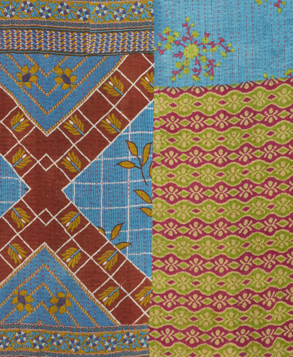 kantha quilt throw with a tag featuring the hand-stitched signature of the maker