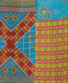 kantha quilt throw with a tag featuring the hand-stitched signature of the maker
