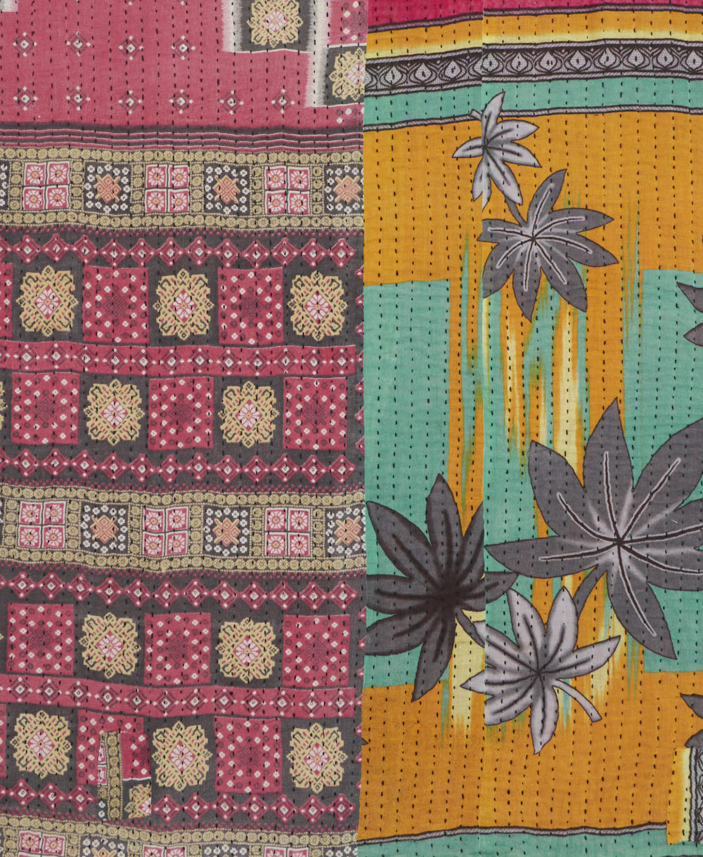 kantha quilt throw with a tag featuring the hand-stitched signature of the maker