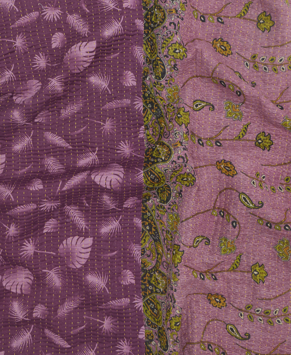 kantha quilt throw with a tag featuring the hand-stitched signature of the maker