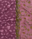 kantha quilt throw with a tag featuring the hand-stitched signature of the maker