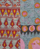 kantha quilt throw with a tag featuring the hand-stitched signature of the maker