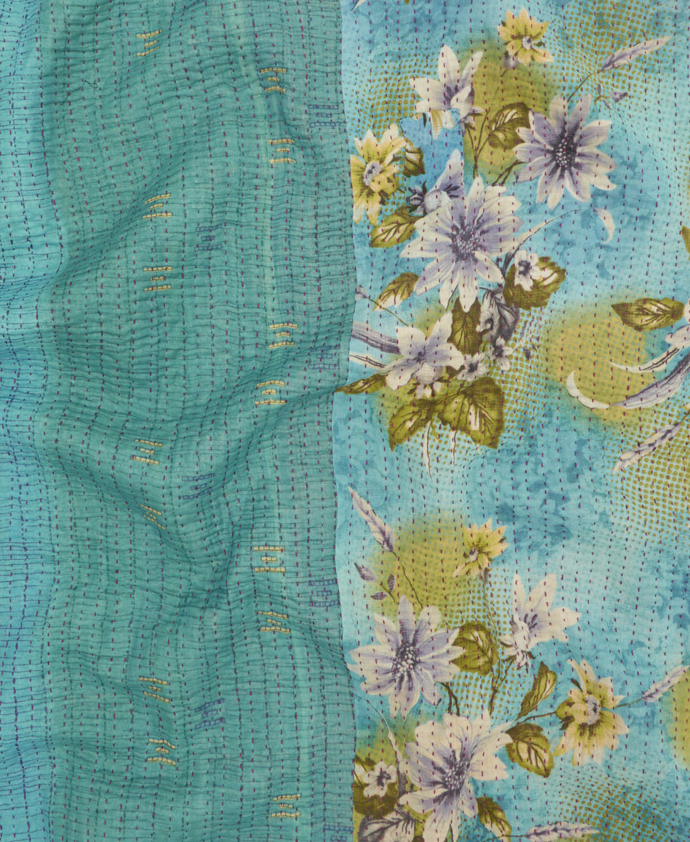 kantha quilt throw with a tag featuring the hand-stitched signature of the maker