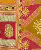 kantha quilt throw with a tag featuring the hand-stitched signature of the maker