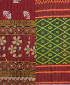kantha quilt throw with a tag featuring the hand-stitched signature of the maker