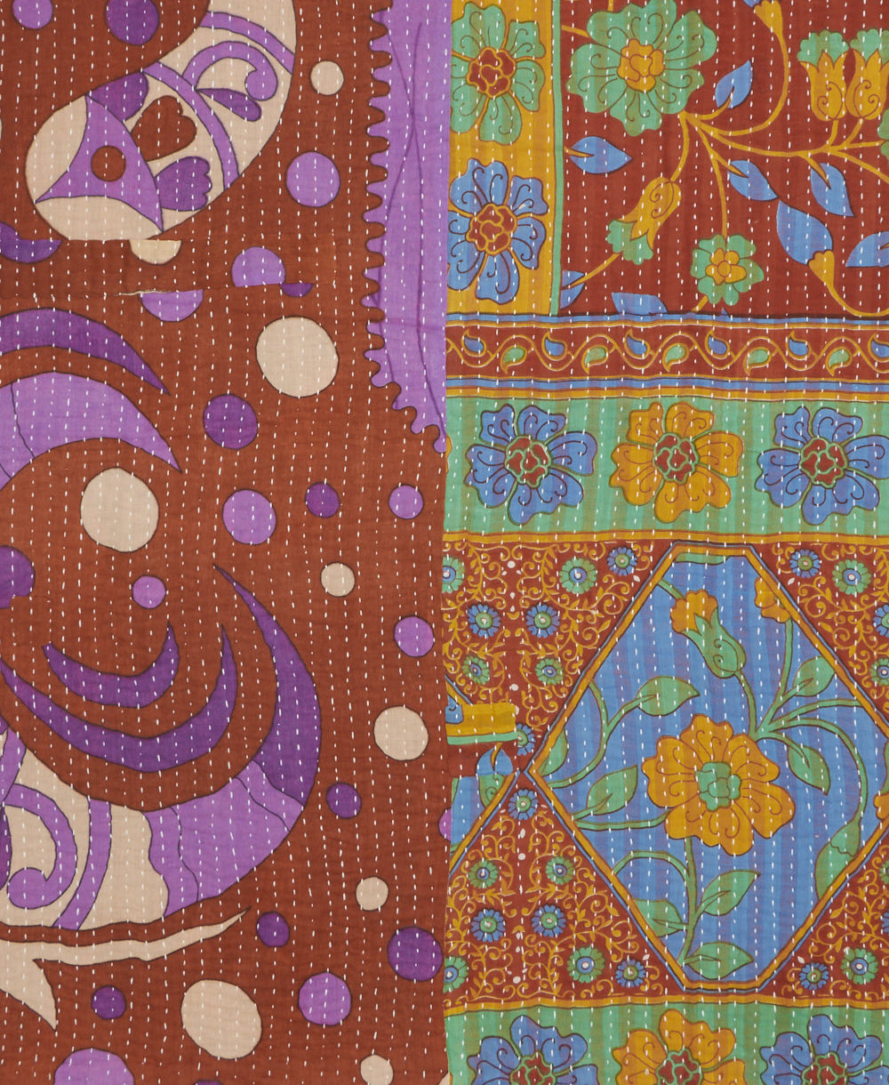 kantha quilt throw with a tag featuring the hand-stitched signature of the maker