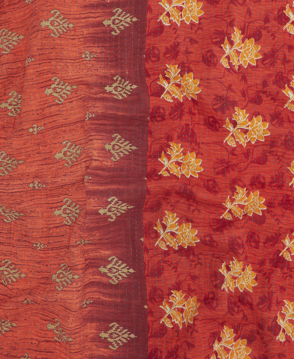 kantha quilt throw with a tag featuring the hand-stitched signature of the maker
