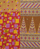 kantha quilt throw with a tag featuring the hand-stitched signature of the maker