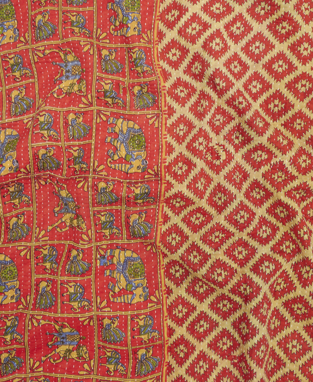 kantha quilt throw with a tag featuring the hand-stitched signature of the maker