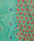 kantha quilt throw with a tag featuring the hand-stitched signature of the maker