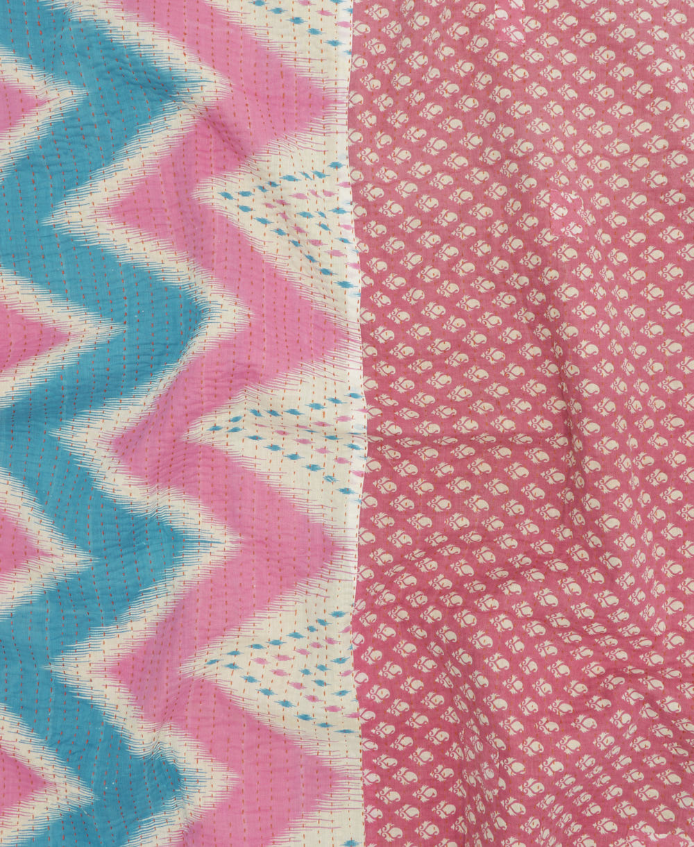 kantha quilt throw with a tag featuring the hand-stitched signature of the maker