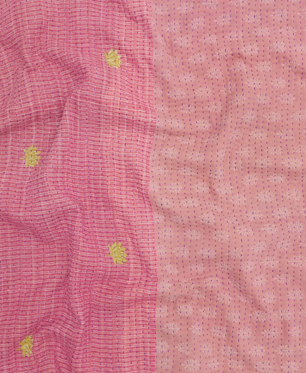 kantha quilt throw with a tag featuring the hand-stitched signature of the maker