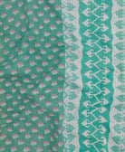 kantha quilt throw with a tag featuring the hand-stitched signature of the maker