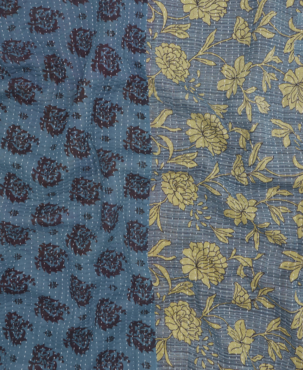kantha quilt throw with a tag featuring the hand-stitched signature of the maker