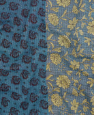 kantha quilt throw with a tag featuring the hand-stitched signature of the maker