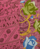 kantha quilt throw with a tag featuring the hand-stitched signature of the maker