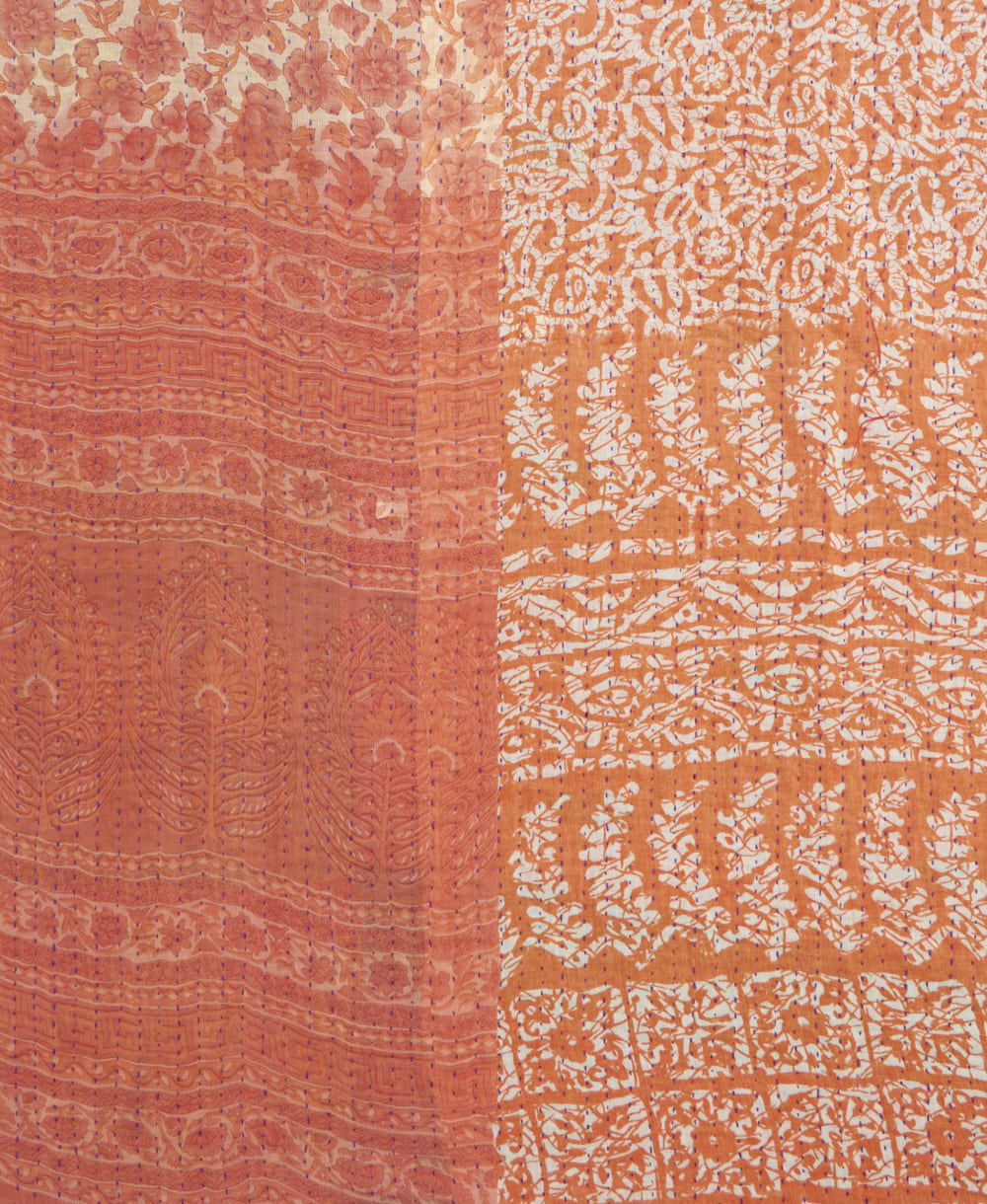 kantha quilt throw with a tag featuring the hand-stitched signature of the maker