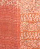 kantha quilt throw with a tag featuring the hand-stitched signature of the maker