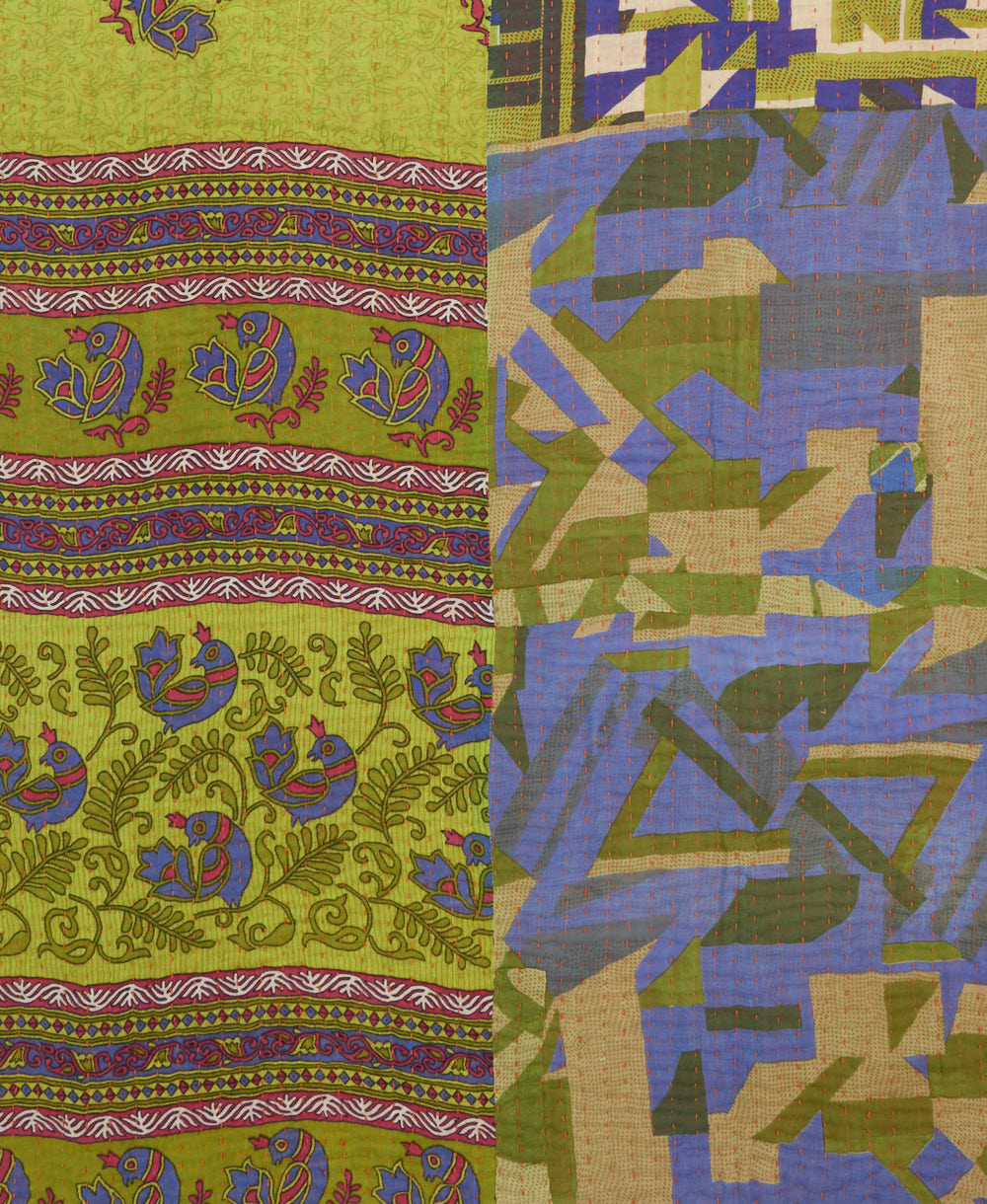 kantha quilt throw with a tag featuring the hand-stitched signature of the maker