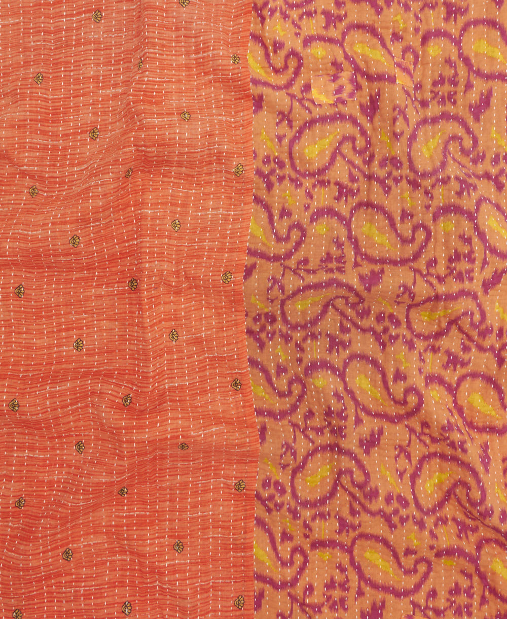 kantha quilt throw with a tag featuring the hand-stitched signature of the maker