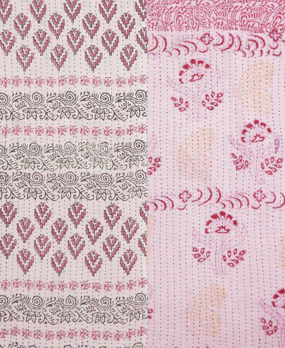 kantha quilt throw with a tag featuring the hand-stitched signature of the maker