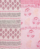kantha quilt throw with a tag featuring the hand-stitched signature of the maker
