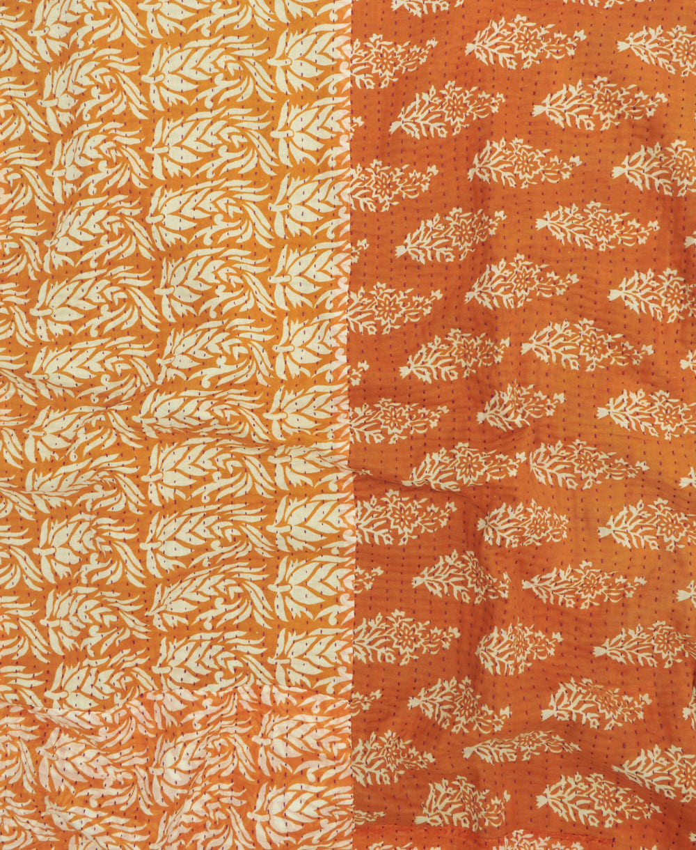 kantha quilt throw with a tag featuring the hand-stitched signature of the maker