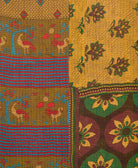kantha quilt throw with a tag featuring the hand-stitched signature of the maker