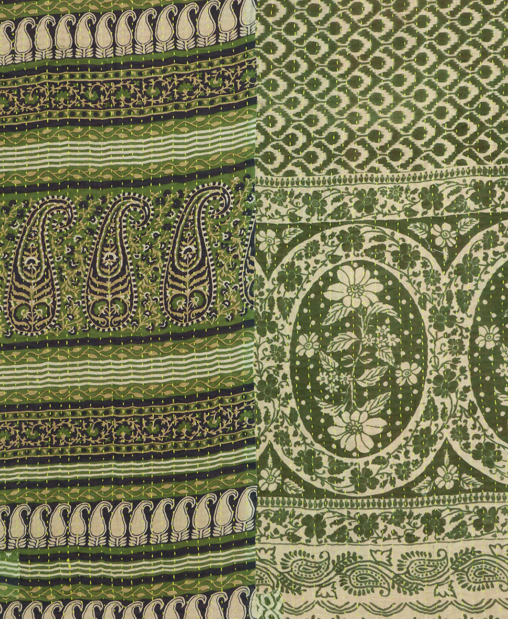 kantha quilt throw with a tag featuring the hand-stitched signature of the maker