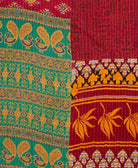 kantha quilt throw with a tag featuring the hand-stitched signature of the maker