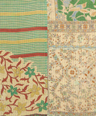 kantha quilt throw with a tag featuring the hand-stitched signature of the maker