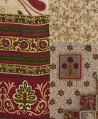 kantha quilt throw with a tag featuring the hand-stitched signature of the maker