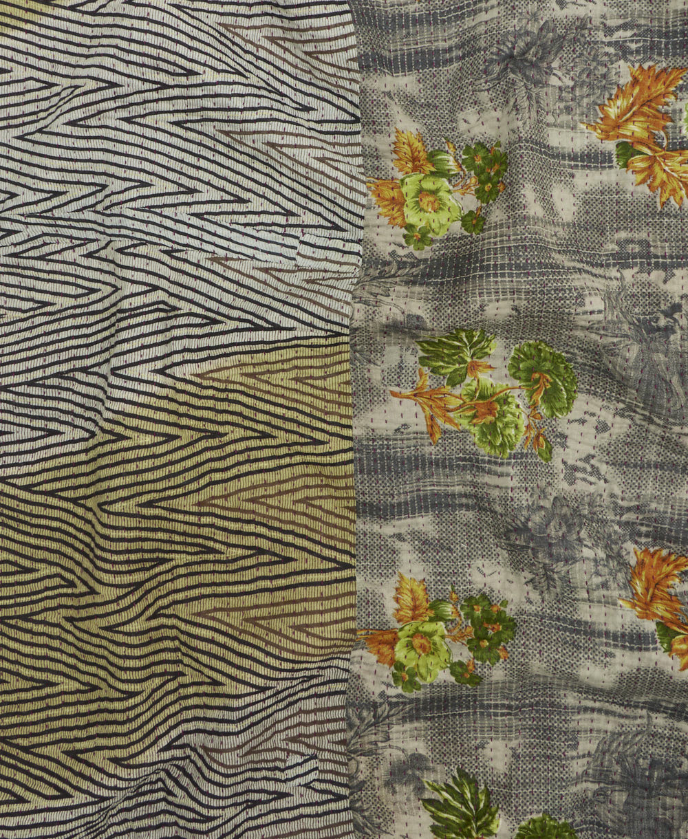 kantha quilt throw with a tag featuring the hand-stitched signature of the maker