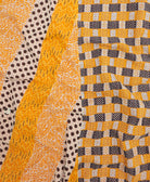 kantha quilt throw with a tag featuring the hand-stitched signature of the maker