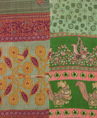 kantha quilt throw with a tag featuring the hand-stitched signature of the maker