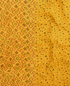kantha quilt throw with a tag featuring the hand-stitched signature of the maker