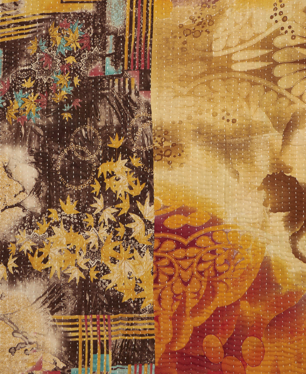 kantha quilt throw with a tag featuring the hand-stitched signature of the maker