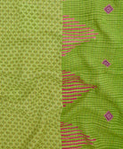 kantha quilt throw with a tag featuring the hand-stitched signature of the maker