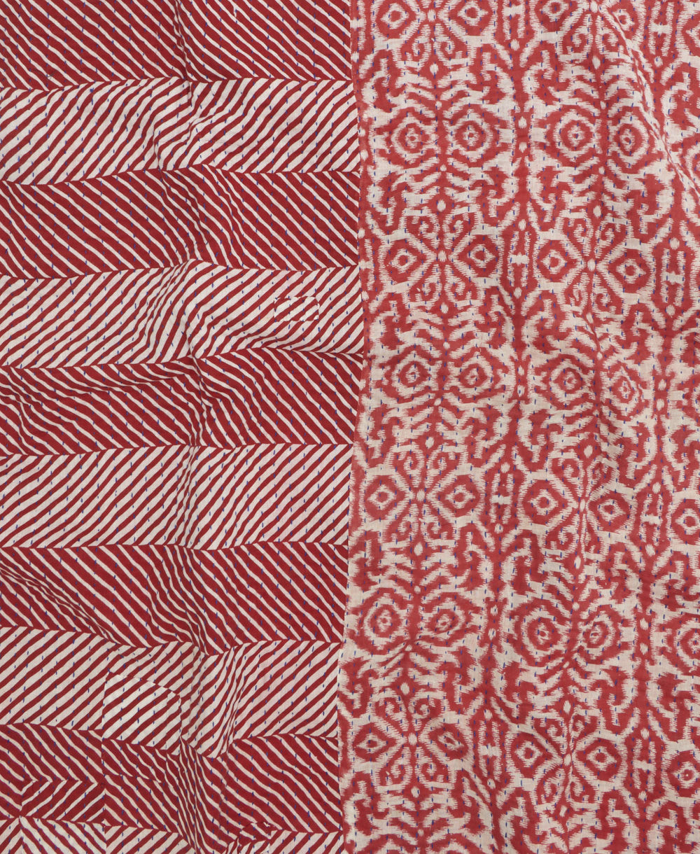 kantha quilt throw with a tag featuring the hand-stitched signature of the maker