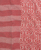 kantha quilt throw with a tag featuring the hand-stitched signature of the maker