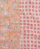 kantha quilt throw with a tag featuring the hand-stitched signature of the maker