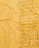 kantha quilt throw with a tag featuring the hand-stitched signature of the maker