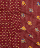 kantha quilt throw with a tag featuring the hand-stitched signature of the maker