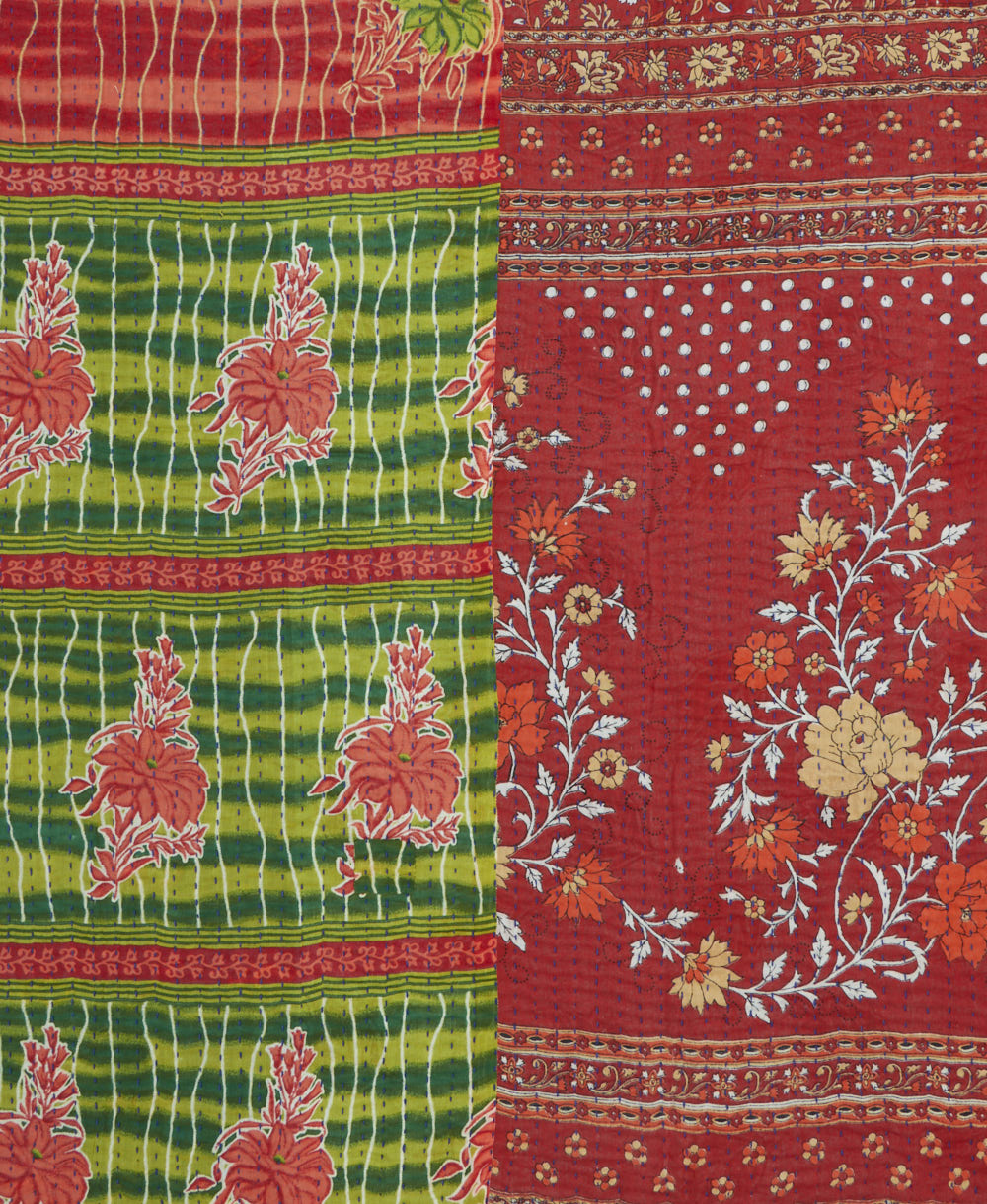 kantha quilt throw with a tag featuring the hand-stitched signature of the maker