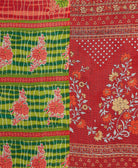 kantha quilt throw with a tag featuring the hand-stitched signature of the maker