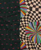 kantha quilt throw with a tag featuring the hand-stitched signature of the maker