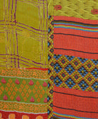 kantha quilt throw with a tag featuring the hand-stitched signature of the maker