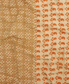 kantha quilt throw with a tag featuring the hand-stitched signature of the maker