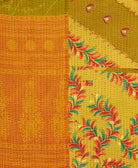 kantha quilt throw with a tag featuring the hand-stitched signature of the maker