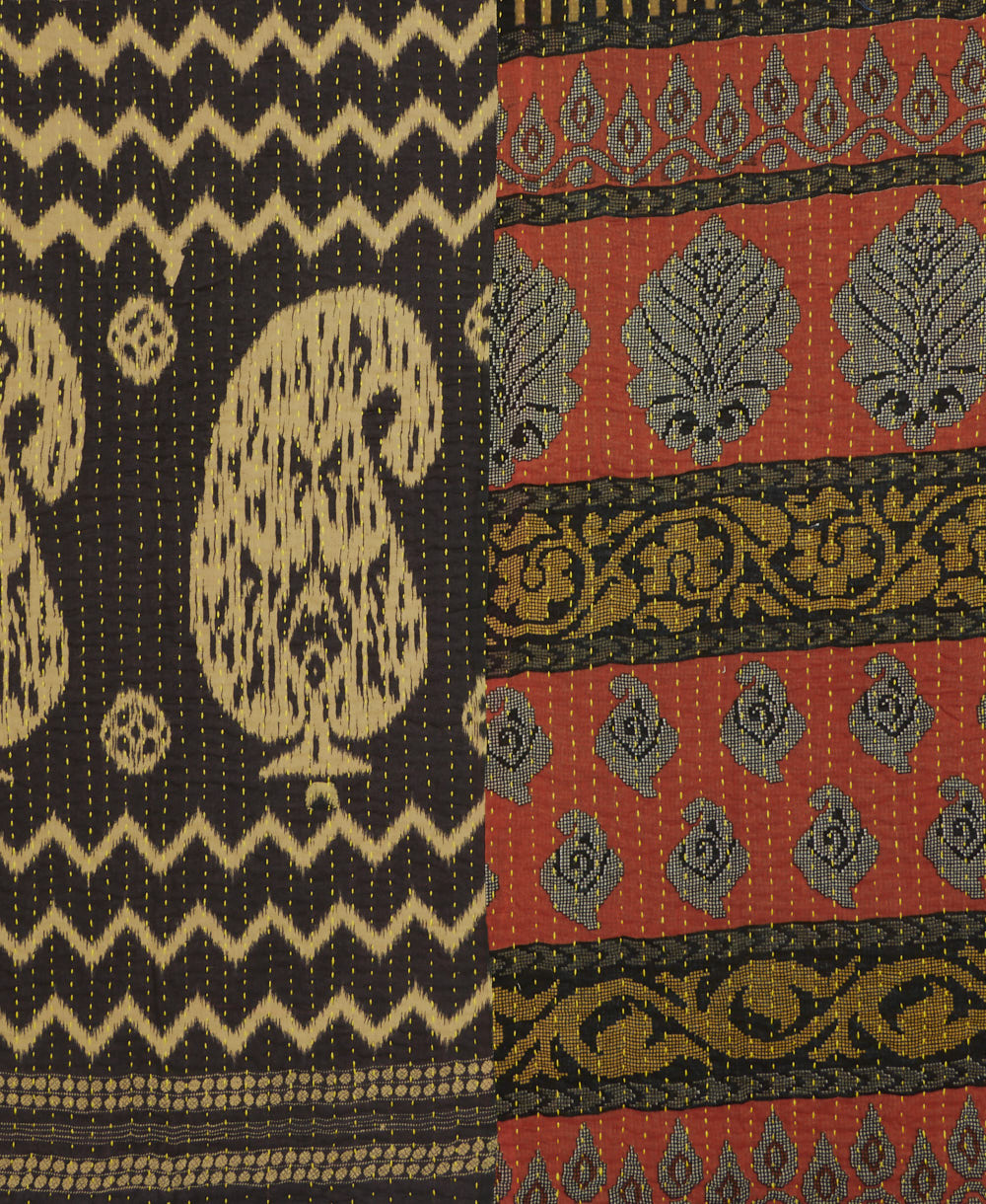 kantha quilt throw with a tag featuring the hand-stitched signature of the maker